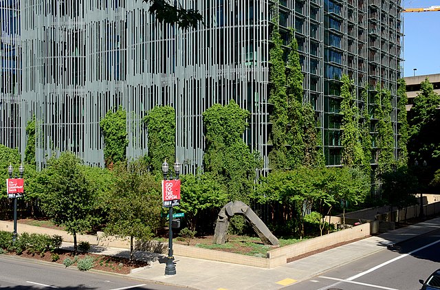 Base of the Wendell-Wyatt Federal Center with green vines growing up from its base.