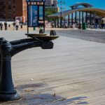Photograph of public water fountains on a boardwalk.