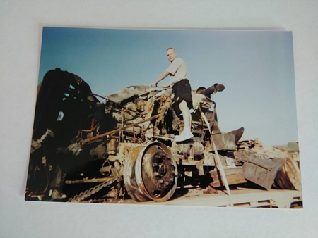 Color photograph of chapter co-author, Troy Richard, standing on a military vehicle.