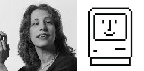 Photograph of Susan Kare looking to the right with the Happy Mac icon she designed next to her.