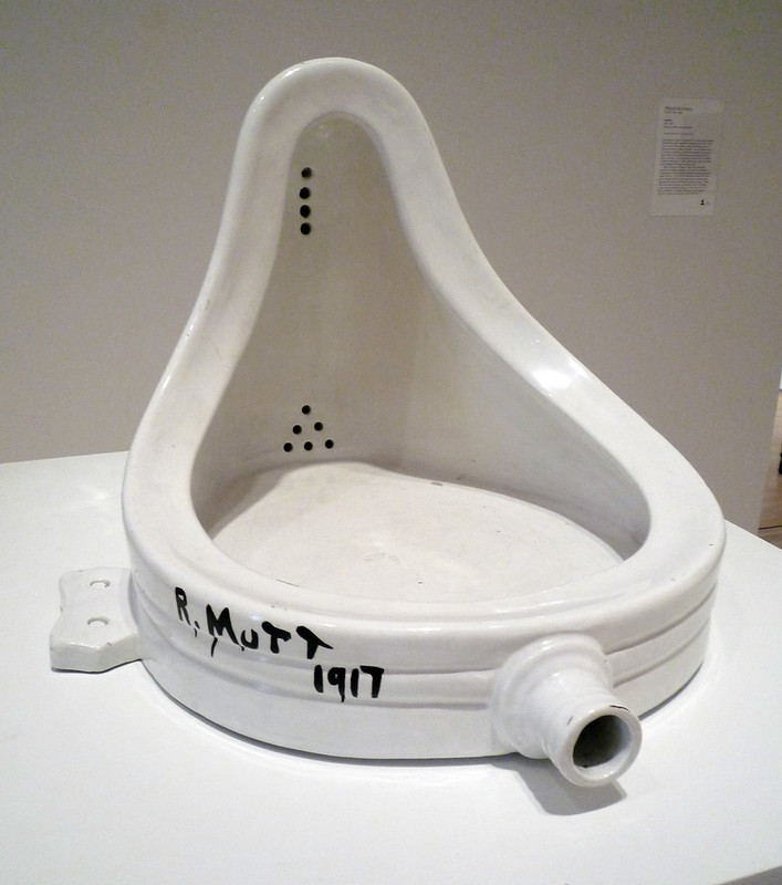 White porcelain urinal on it's back on a pedestal. Signed R. Mutt and dated 1917.