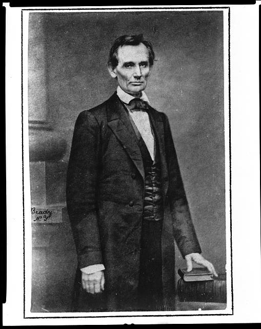 Abraham Lincoln, three-quarter length portrait, standing, facing slightly right.