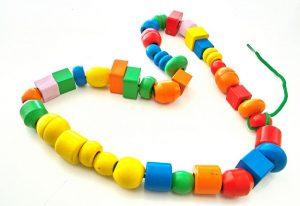 photo of different colors and shapes of beads on a string