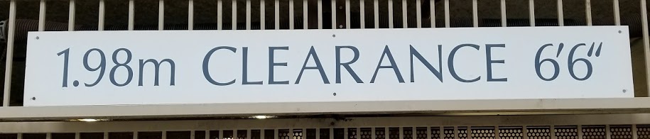 Vancouver, BC: a sign at a parking garage reading "1.98 m CLEARANCE 6 ft 6 in"