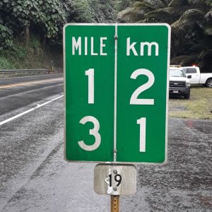 Hawaii: a road sign stating that 13 miles equals 21 kilometers
