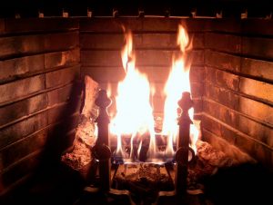 A fire burning in an open fireplace.