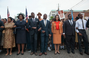 Screen snip of MLK Jr. and marchers crossing the Selma Bridge from the film Selma