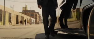 Will Salas getting into the car in the Ghetto. Note the bars on the windows and unmaintained roads - Screenshot In Time (2011)  .