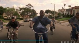 Jody biking amongst children after Yvette takes her car away from him (Screenshot)