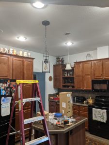 kitchen with ladder and hanging light fixture