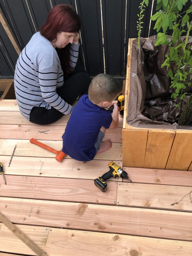 child using tool with adult