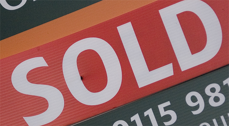 Close-up image of a “sold” sign.