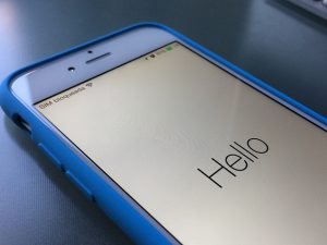 a photo of an iPhone 6 with the word &quot;hello&quot; displayed at start up