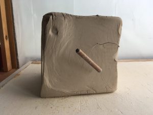 a large block of unsculpted pottery clay