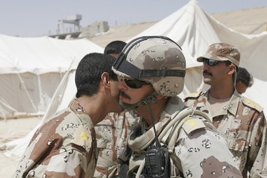 two soldiers kissing each other on the cheek as a greeting