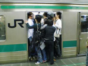 People trying to fit on to train in Tokyo.