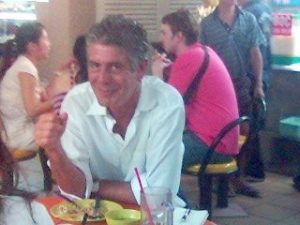 Anthony Bourdain eating at a cafe in Singapore.