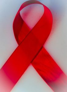 A red ribbon signifying AIDS awareness.