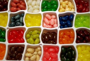 Jelly beans sorted into different containers based on flavor.