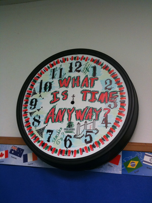 Colorful clock with drawn text saying "what is time anyway?"