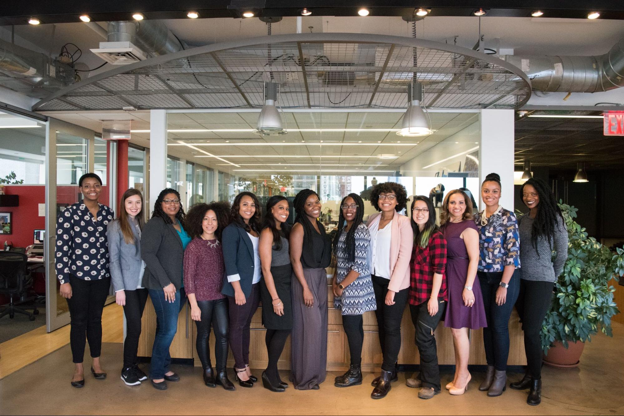 A line of people in an office wearing a variety of styles of clothing