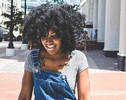 A person with naturally textured African-American hair, sometimes described as kinky hair