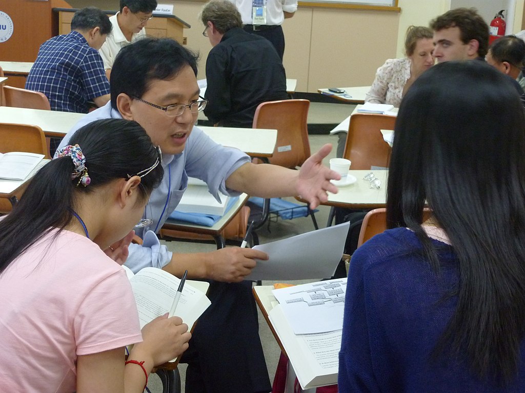 Students in a classroom talking in a small group