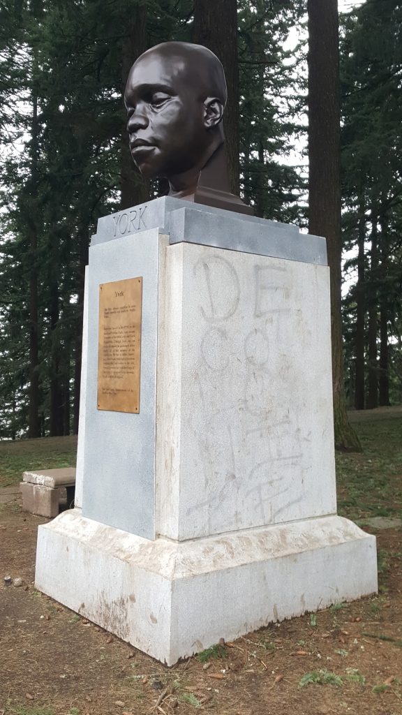 Statue on pedestal in park