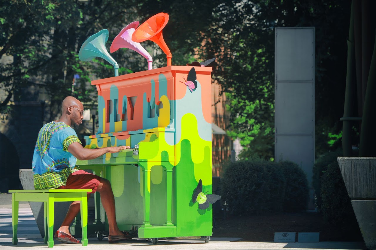 man playing a colorful piano