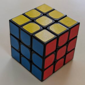 Rubik's cube showing three faces with a 3 by 3 grid on each face