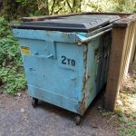 a dumpster labeled "2 yd"