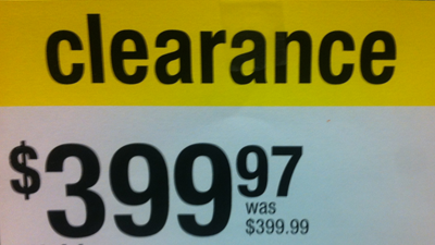 a sign reading "clearance 399.97 dollars, was 399.99 dollars"