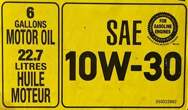 a large box of motor oil labeled "6 gallons" and "22.7 litres"
