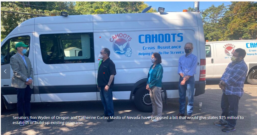 Senator Ron Wyden of Oregon and Catherine Cortez Masto of Nevado with Cahoots staff stand in front of a white van with a CAHOOTS logo
