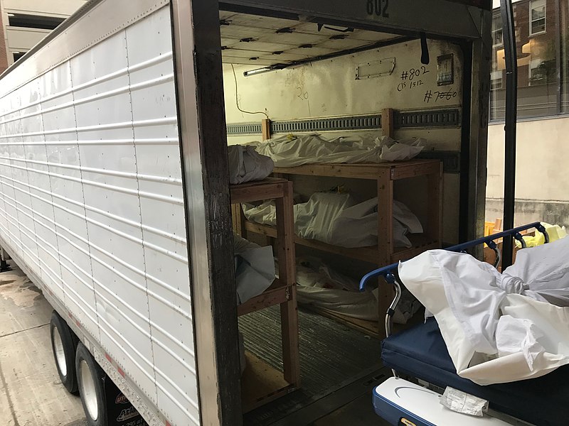 Morgue truck with deceased remains wrapped in sheets