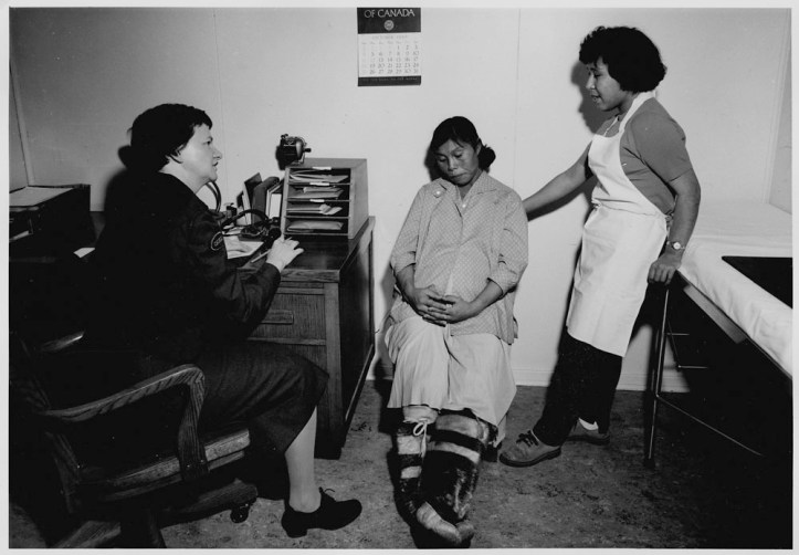 An Indigenous woman receives healthcare in the 1920s.