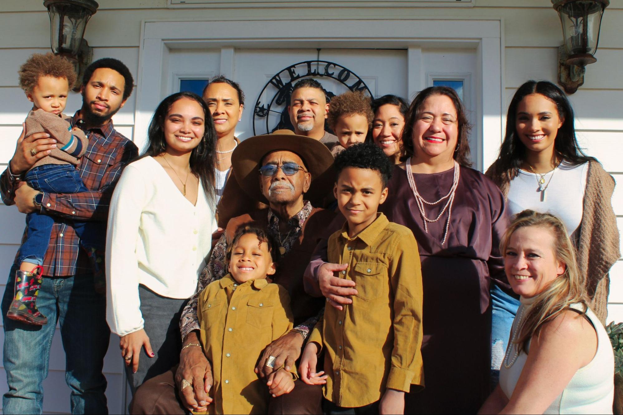 A multigenerational Latinx family is taking a photo together.