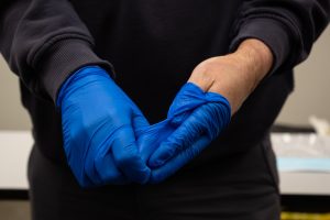 : With the gloved hand, ball up the removed glove.