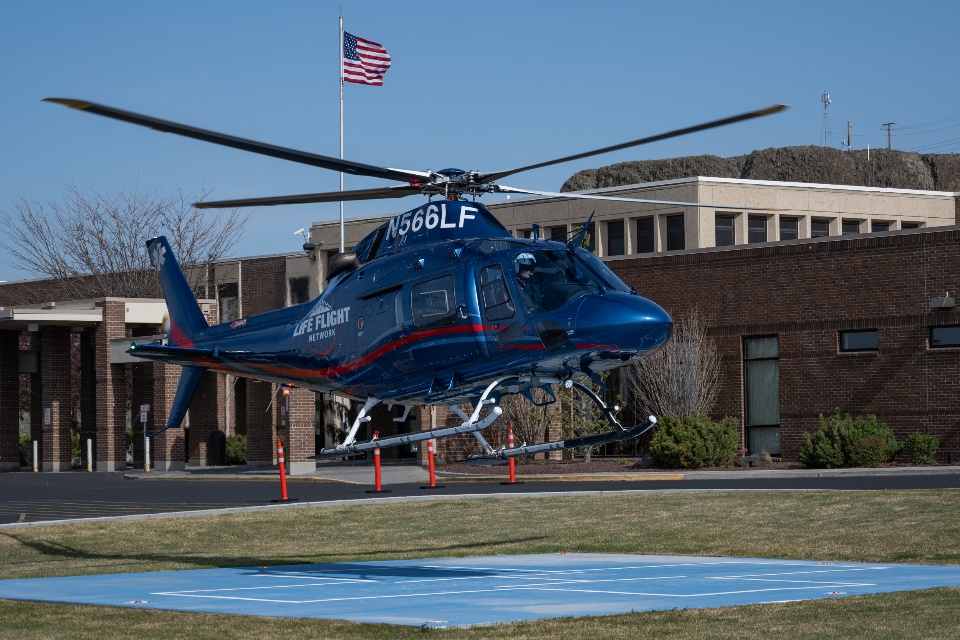 A LIFE flight helicopter lifting off from a landing pad.