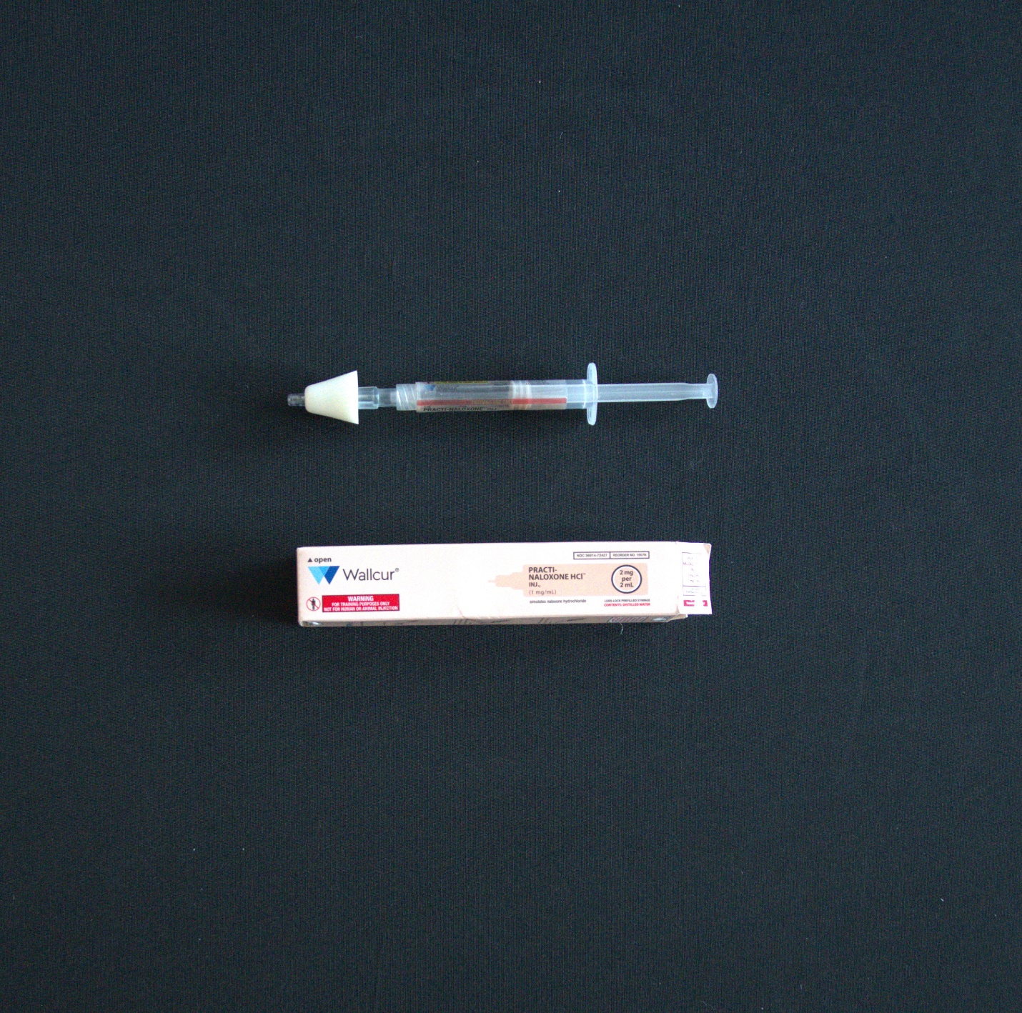 Photo of Narcan with nasal atomizer attached.
