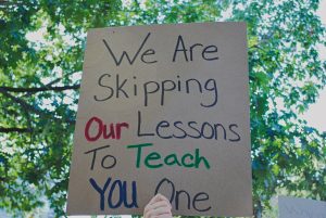 A handwritten sign that says "we are skipping our lessons to teach you one"