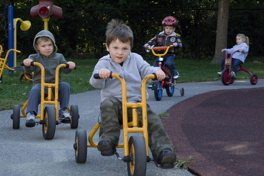 HANSCOM AIR FORCE BASE, Mass. - Michael Flynn, Alex Pavlovic and Tommy Parks (from left to right) ride their tricycles at the Child Development Center on Sept. 21. The CDC children participated in a Trike-a-thon to raise money for St. Jude Childrens Research Hospital. This is the CDC's 23rd year of riding tricycles, and they have raised more than $50,000 toward the cause.