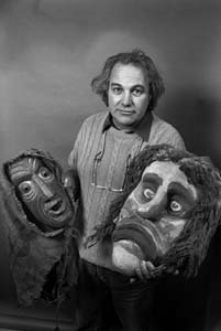 headshot of Bernard Crettaz holding large masks