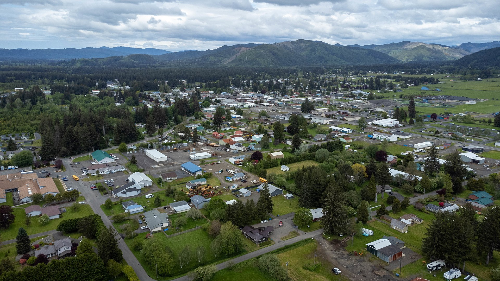 rural town with streets in a grid, surrounded by farmland and low mountains