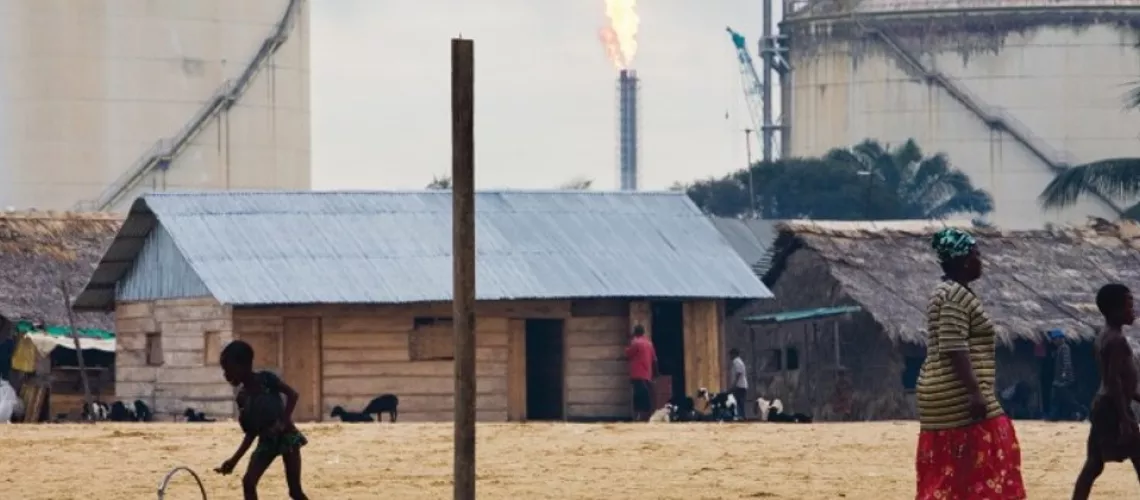 Women, children, pets, and livestock live in homes adjacent to flaming gas flares