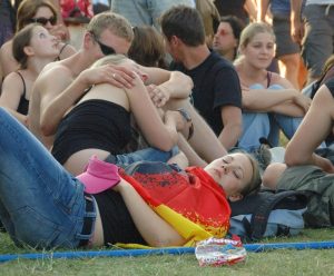 A crowd of seated and snuggling adults.