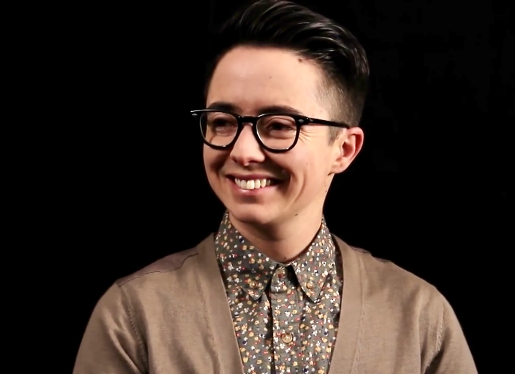 Dean Spade standing in front of a black background.