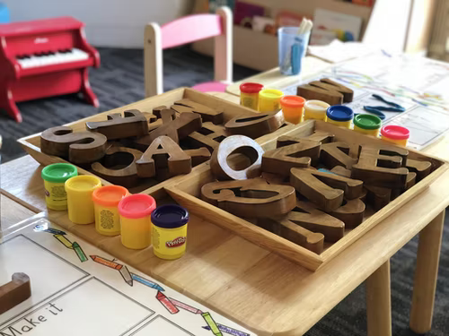 A playroom with art supplies on a table.