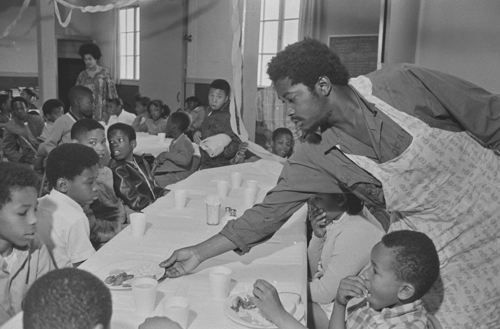 Photograph of Charles Bursey serving children at Panther breakfast program, St. Augustine's Episcopal Church