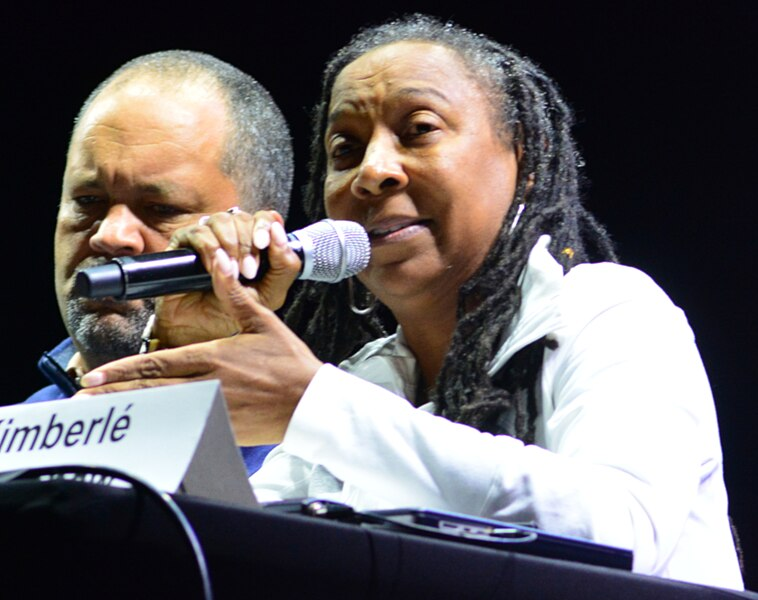 An image of Kimberlé Crenshaw speaking into a microphone.